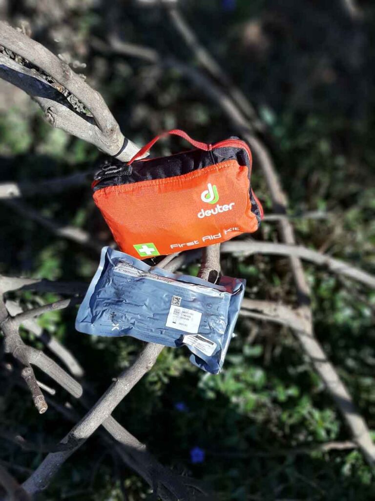 First Aid kit with an Israeli bandage places on twigs on a sunny day