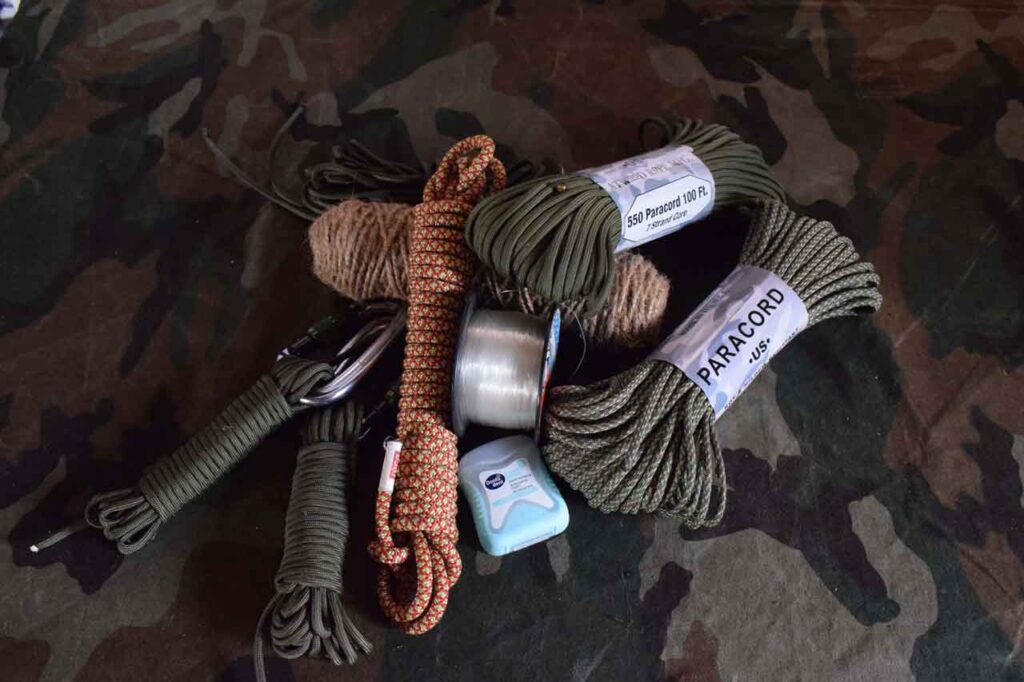 Assorted cordage for a survival bug out bag on a camo background