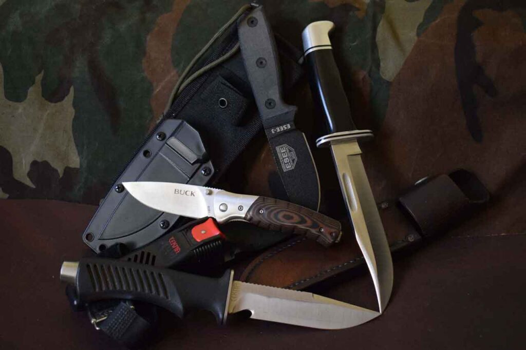 A variety of survival knifes with sheaths for all environments