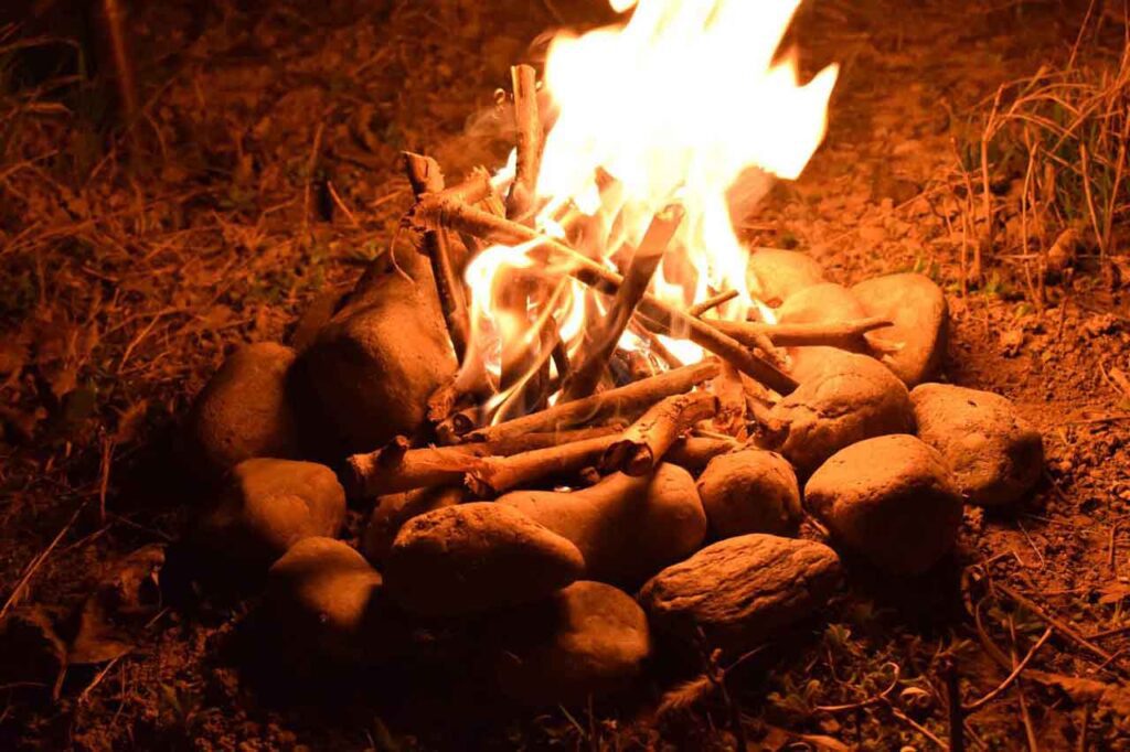 A fire in the woods with stone circle