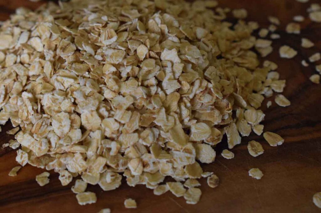 Survival Foods on a Budget, Oats Flakes on a wooden Cutting Borard