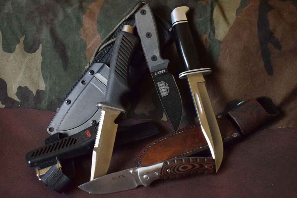 Buck Selkirk Folding Knife arranged on a brown leather and camo background