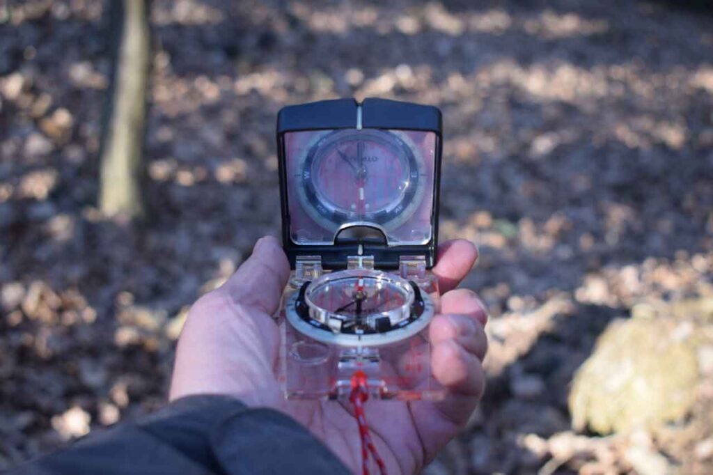 A Mans Hand Holding A Compass